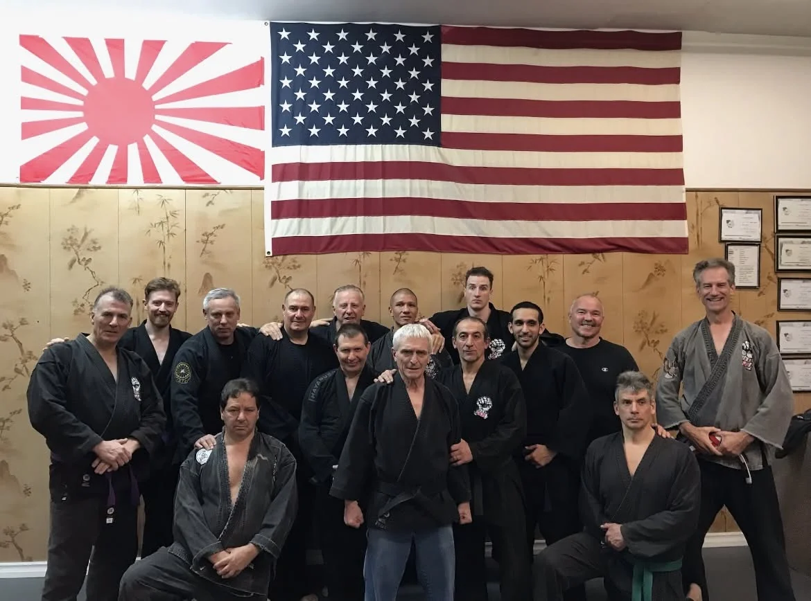 Black belts of Zen Goju Temple on the dojo mat.